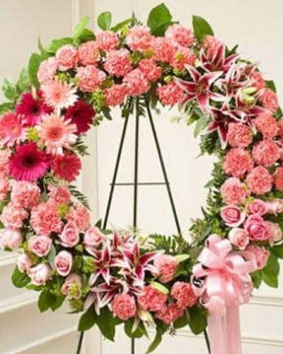 <p>This pink standing wreath perfectly expresses your love and concern at this difficult time. Softly colored flowers such as roses, stargazer lilies, carnations and more are accented by salal and seeded eucalyptus. Traditionally sent directly to the funeral home by family, friends and business associates.</p>