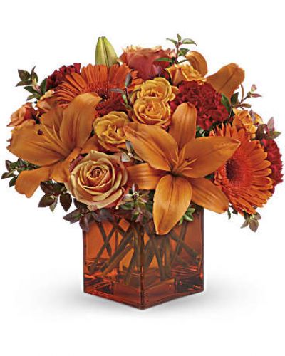 <div id="mark-3" class="m-pdp-tabs-marketing-description">Celebrate the wonder of a new day with warm, golden flowers. A modern orange glass vase is the foundation of this stunning, sun-bright bouquet that energizes any occasion.</div>
<del> </del>

&nbsp;
<ul>
 	<li>Orange gerbera daisies, orange roses and red mini carnations are accented with a spray of red huckleberry in an orange cube</li>
</ul>
<div id="desc-3">
<ul>
 	<li>vase.</li>
</ul>
</div>
&nbsp;
<ul>
 	<li></li>
</ul>
&nbsp;