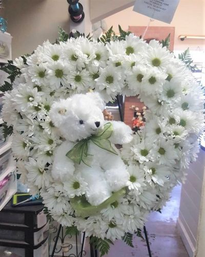 <p>Send love and hugs with this sweet wreath featuring a keepsake plush. From welcoming a new baby to care and concern, this thoughtful arrangement will speak volumes when words may fail.</p>
